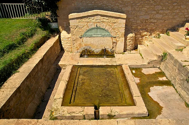 The public fountain of 1851 in Montignac, with its stone basin and wash trough, near the Vézère